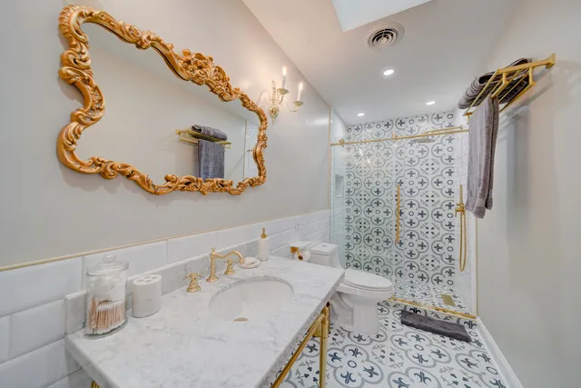 a bathroom with a sink toilet and shower