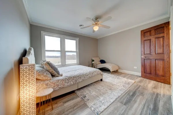 a bedroom with a large bed and a chandelier