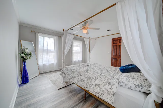 a bedroom with a bed and a window