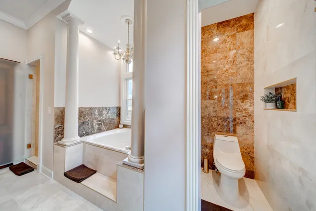 a bathroom with a toilet sink and shower