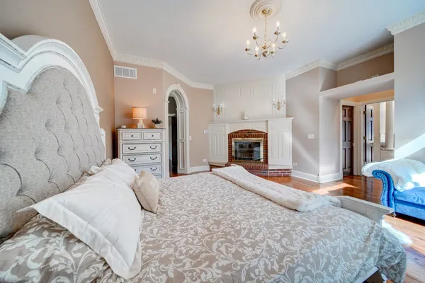 a bedroom with a large bed and a dresser