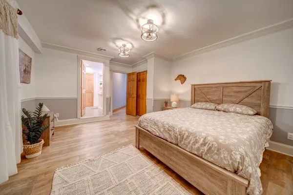 a bedroom with a bed and a chandelier