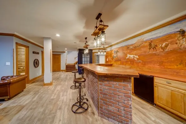 a view of a living room and kitchen with wooden floor