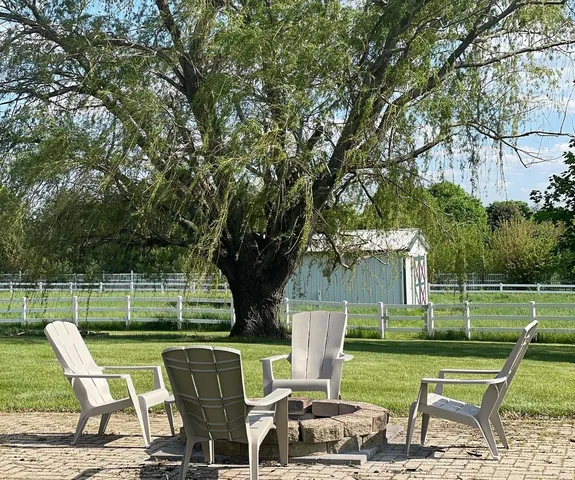 a view of a chair and tables in the yard