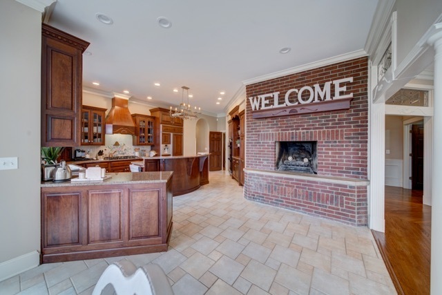 3870 North 3000 W Road Bourbonnais, IL 60914 - Photo 10 of 47 a living room with furniture a fireplace and kitchen view