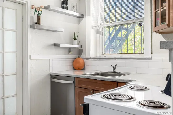 a kitchen with a sink stove and cabinets