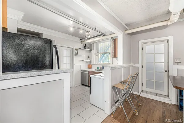 a kitchen with refrigerator cabinets and chair