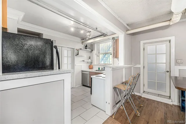 a kitchen with refrigerator cabinets and chair