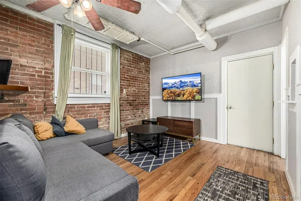 a living room with furniture and wooden floor