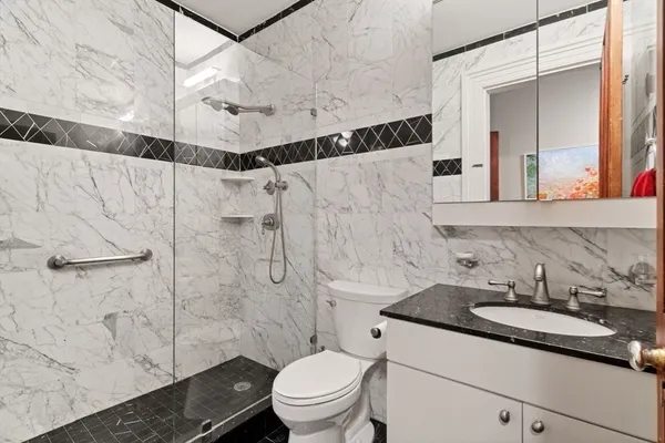 a bathroom with a sink toilet and shower