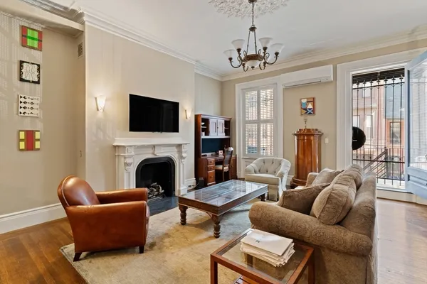 a living room with furniture a fireplace and a flat screen tv