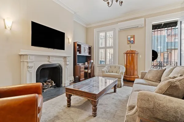 a living room with furniture fireplace and flat screen tv