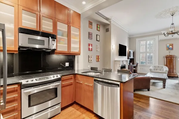 a kitchen with stainless steel appliances a stove microwave and sink