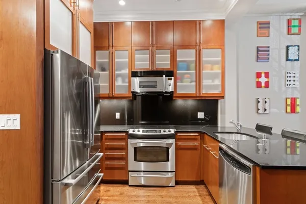 a kitchen with stainless steel appliances a stove a refrigerator and a sink