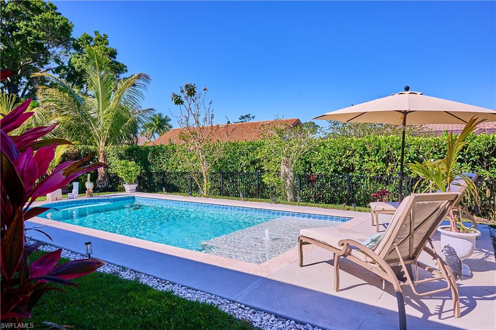 186 Muirfield Circle Naples, FL 34113 - Photo 14 of 36 a view of a chairs and table in the yard