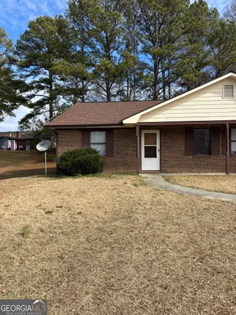 a front view of a house with yard
