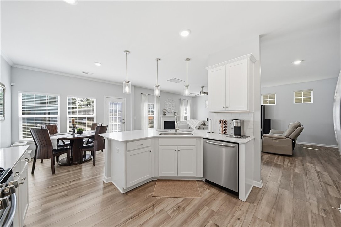 208 Grassy Creek Way Pendleton, SC 29670 - Photo 12 of 43 A streamlined open-concept living space integrates a pristine white kitchen with a cozy dining area and a comfortable family room.