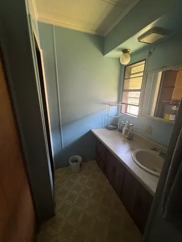 a bathroom with a sink a toilet a mirror and window