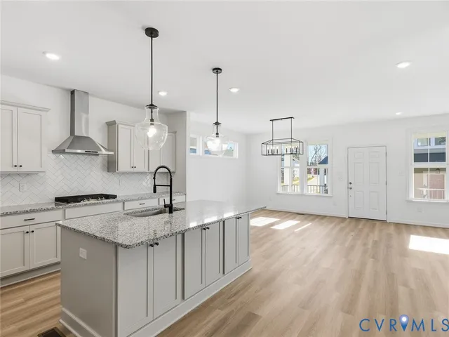 a kitchen with granite countertop a sink a counter space appliances and cabinets