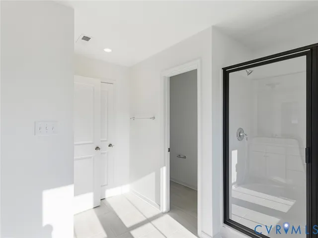 a bathroom with a shower and a glass door