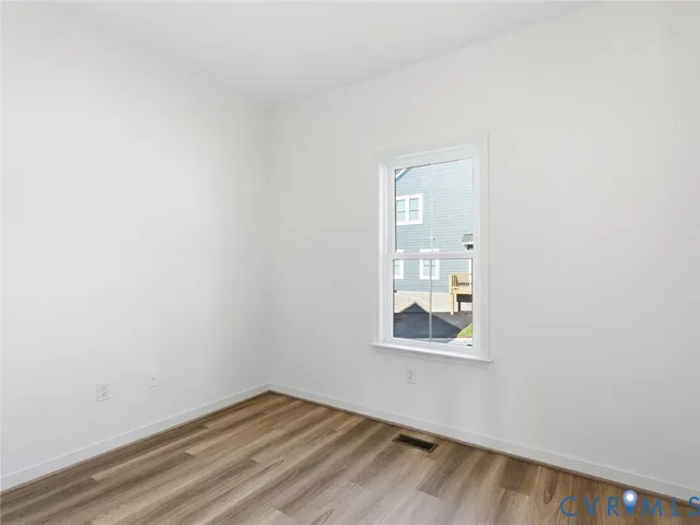 a room with a window and wooden floor