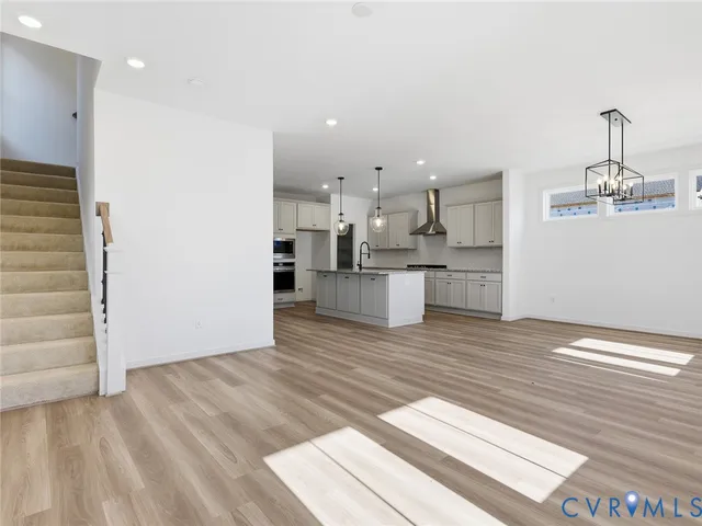 a view of a kitchen with wooden floor and a sink