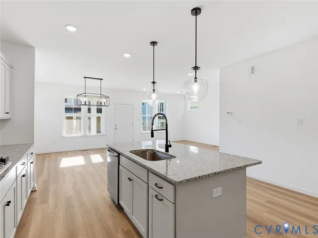 a view of a kitchen with a sink and center island