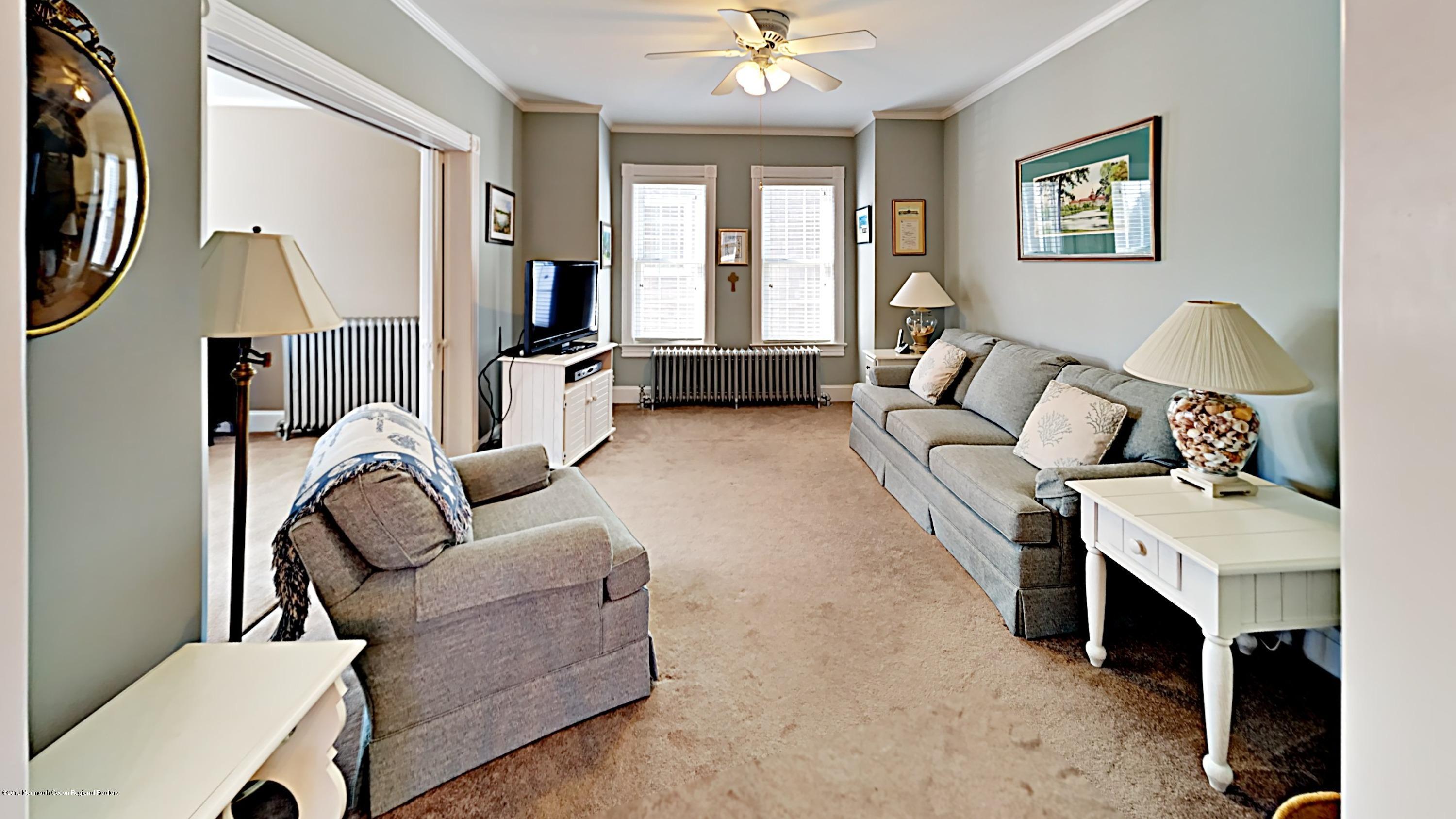 606 Ocean Road Spring Lake Heights, NJ 07762 - Photo 11 of 42 a living room with furniture and a large window
