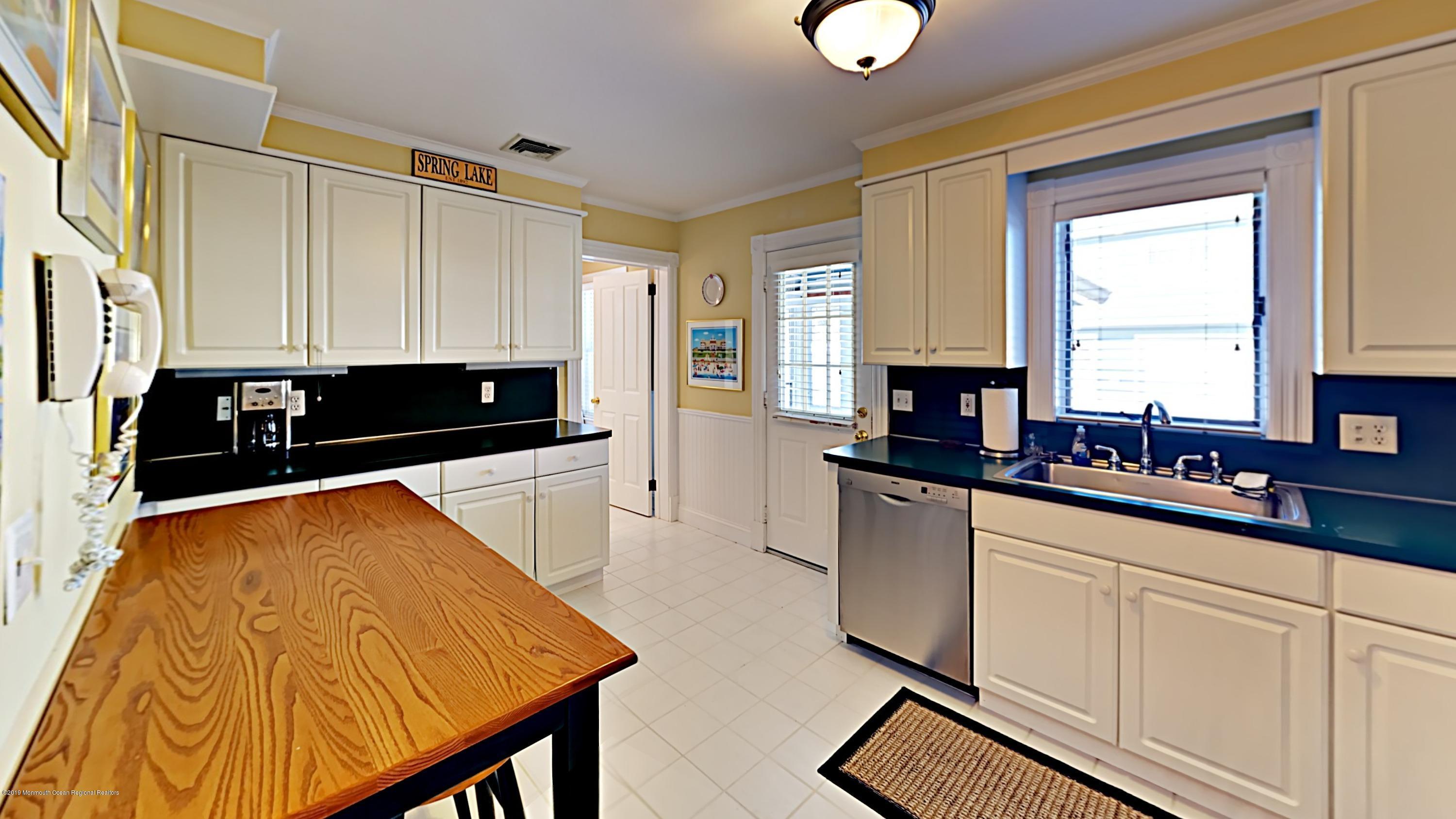 606 Ocean Road Spring Lake Heights, NJ 07762 - Photo 16 of 42 a kitchen with a sink and cabinets