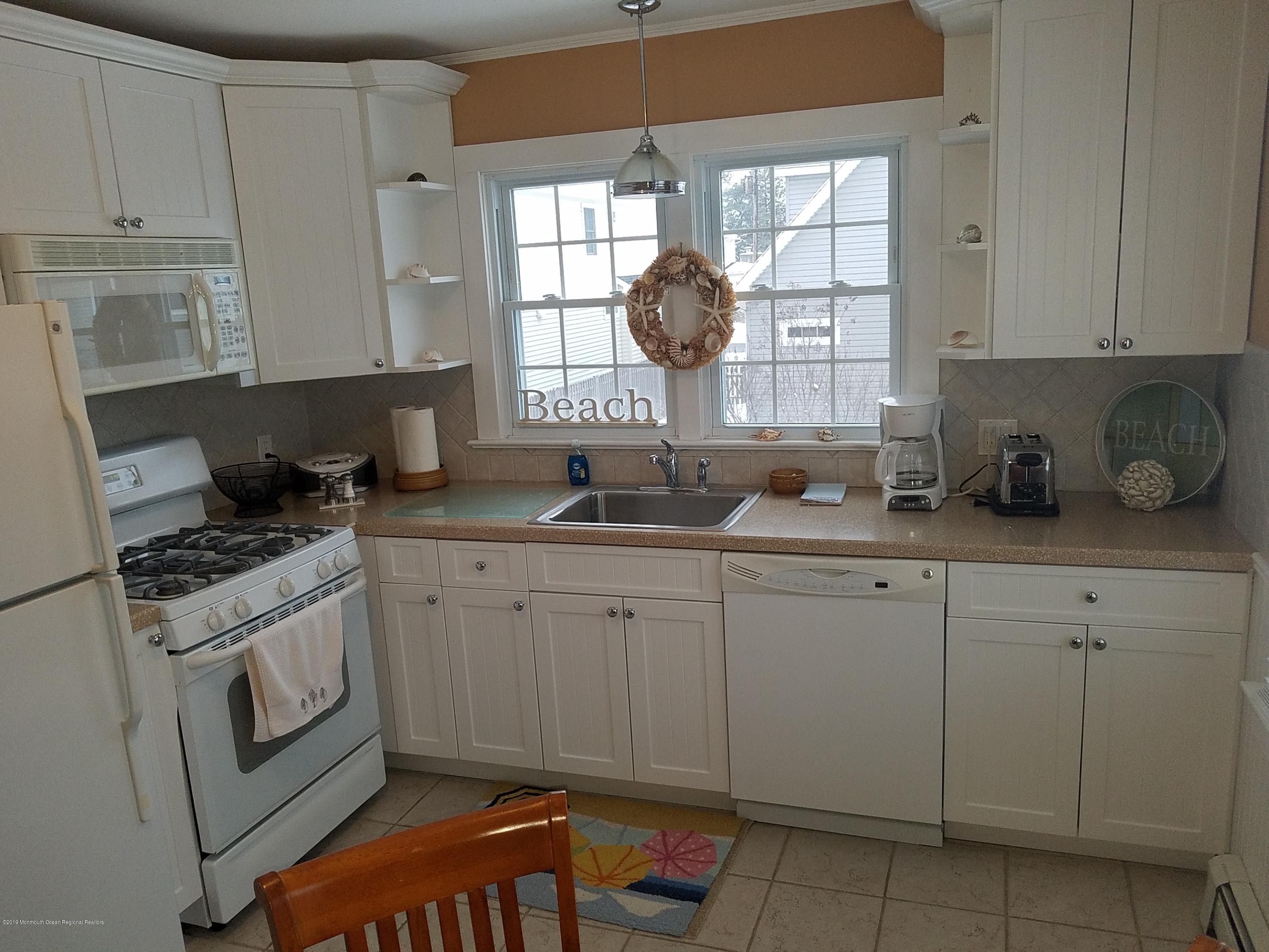 606 Ocean Road Spring Lake Heights, NJ 07762 - Photo 35 of 42 a kitchen with granite countertop a sink and a stove