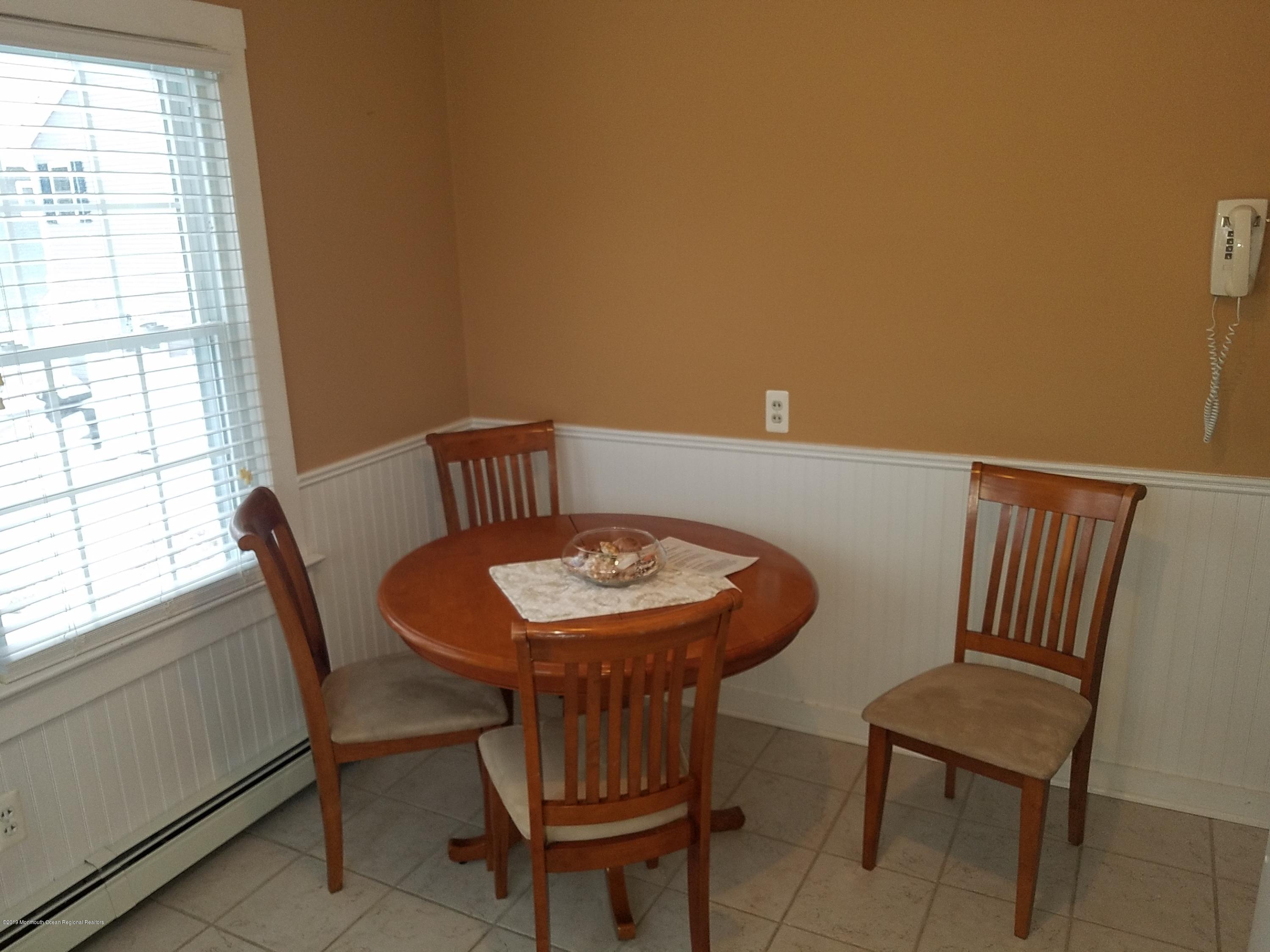 606 Ocean Road Spring Lake Heights, NJ 07762 - Photo 36 of 42 a view of a dining room with furniture and window