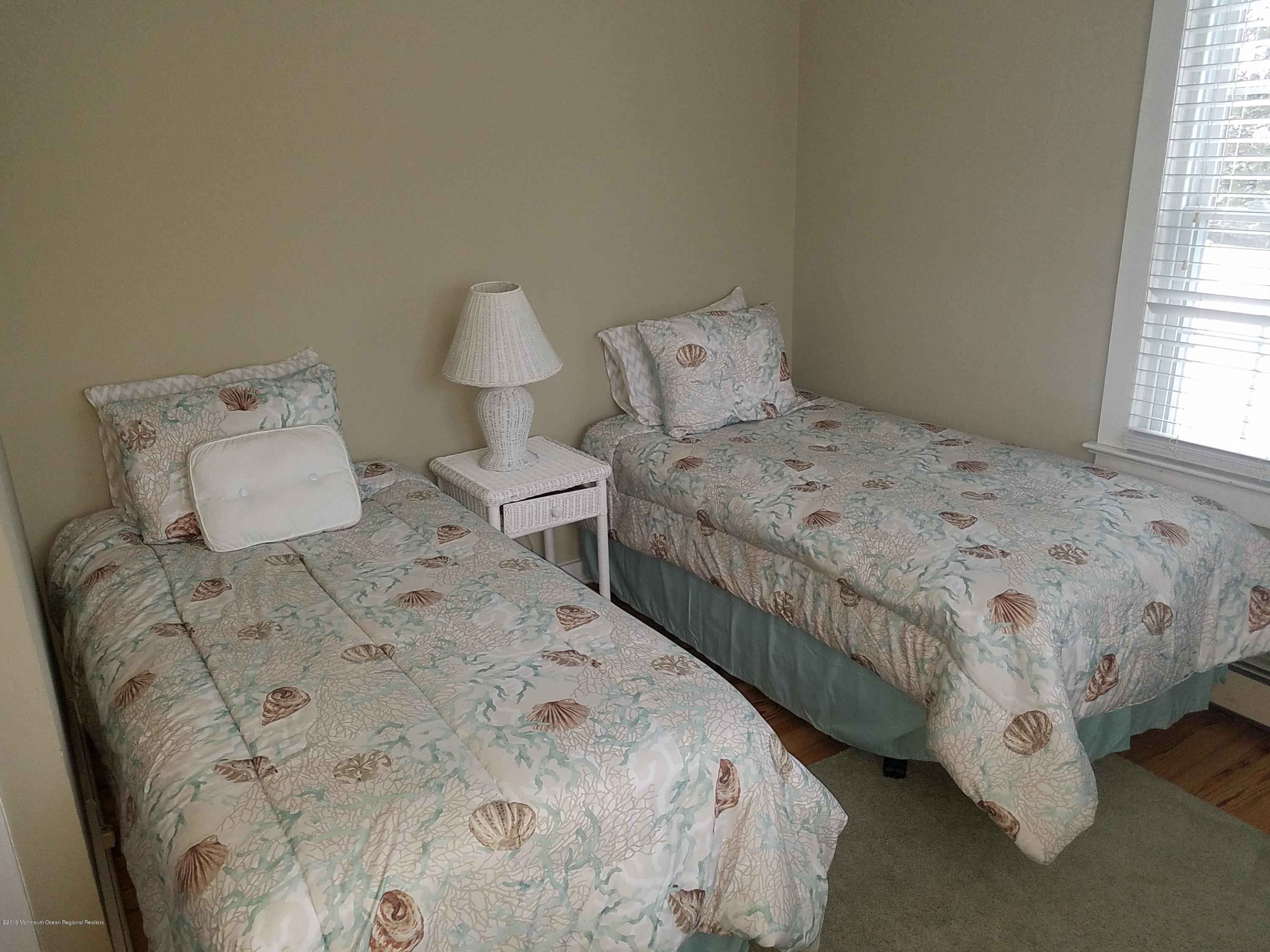 606 Ocean Road Spring Lake Heights, NJ 07762 - Photo 38 of 42 a bedroom with a bed and window