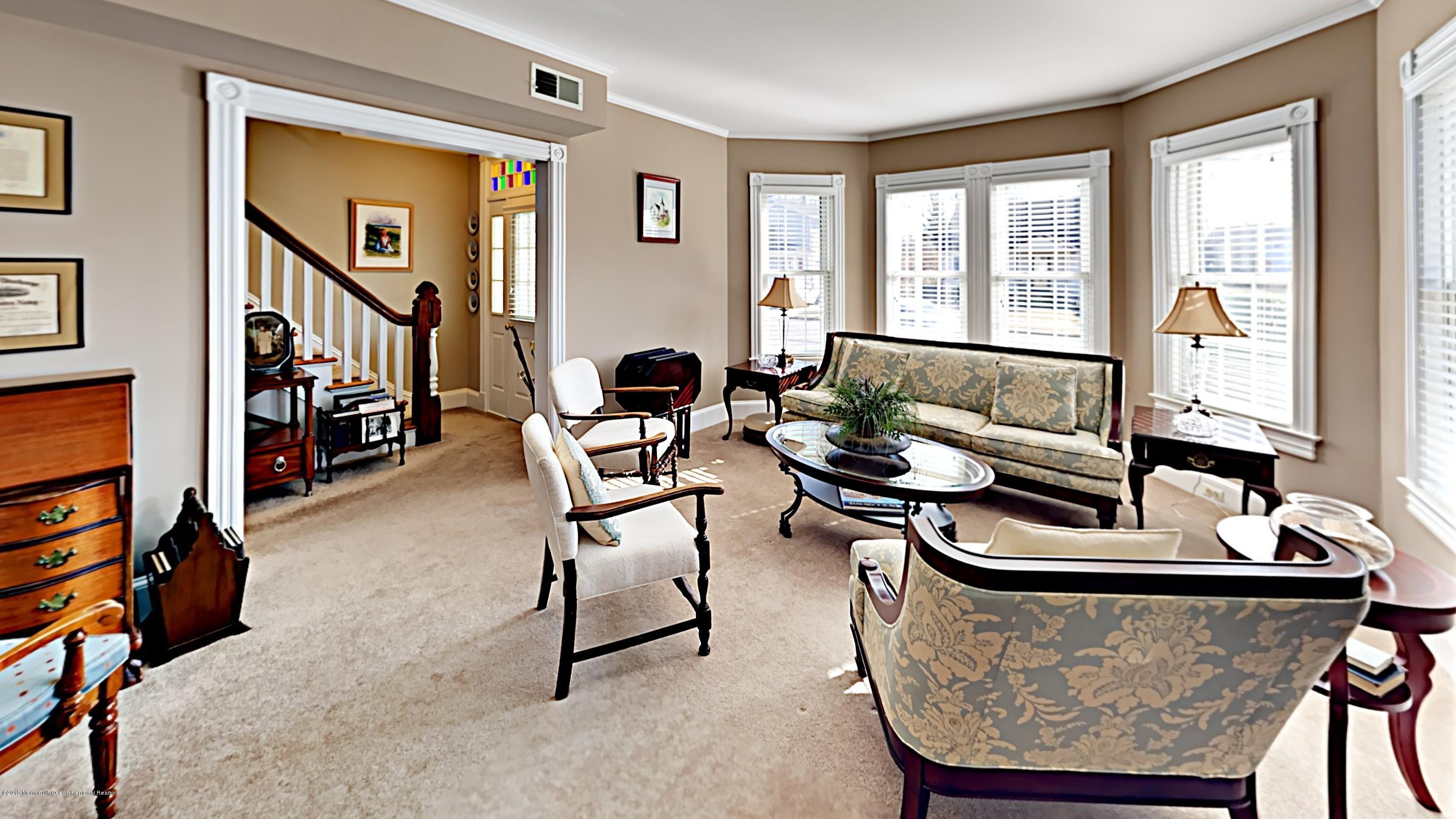 606 Ocean Road Spring Lake Heights, NJ 07762 - Photo 8 of 42 a living room with furniture and a window