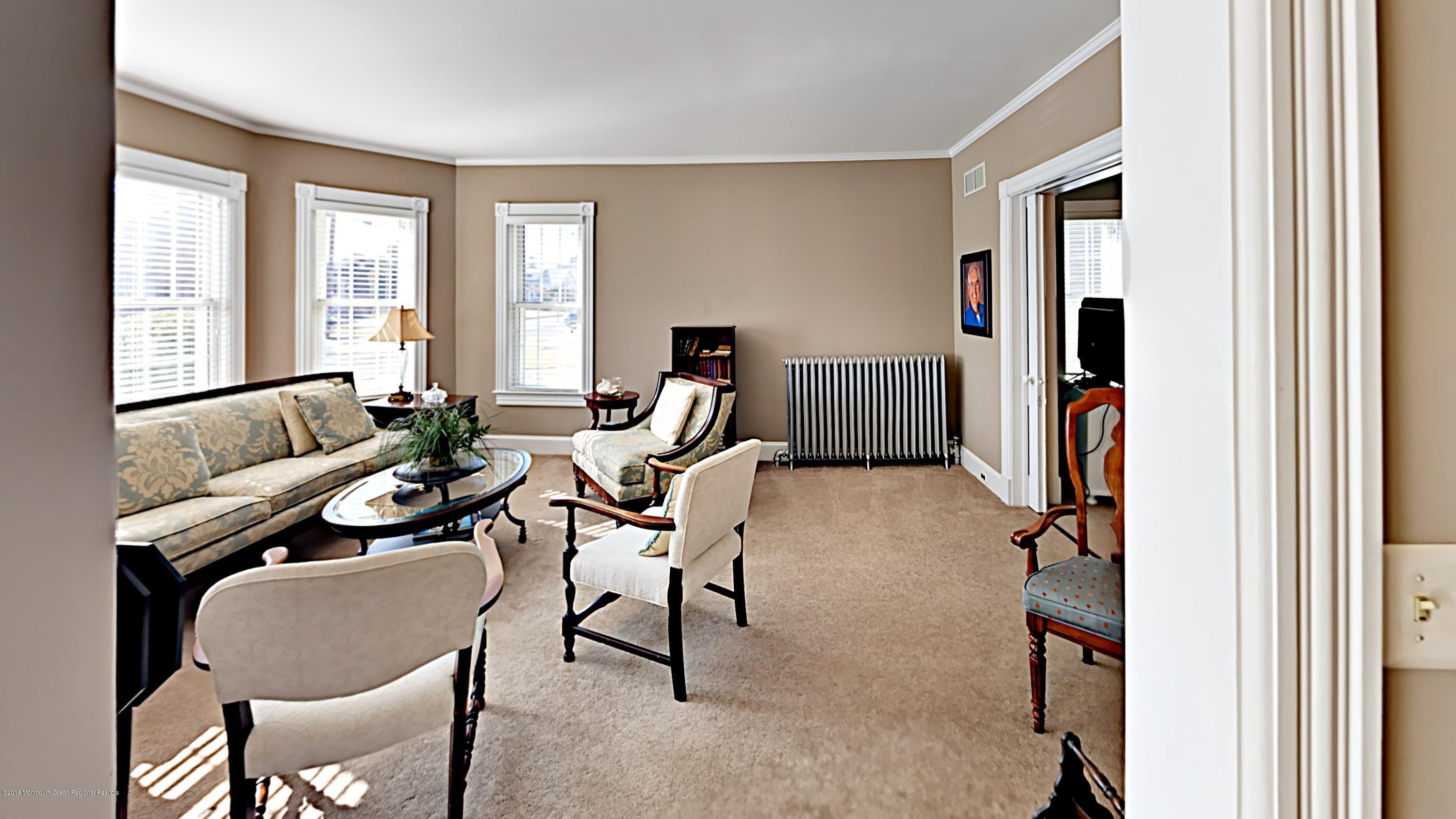 606 Ocean Road Spring Lake Heights, NJ 07762 - Photo 9 of 42 a living room with furniture a window and a flat screen tv