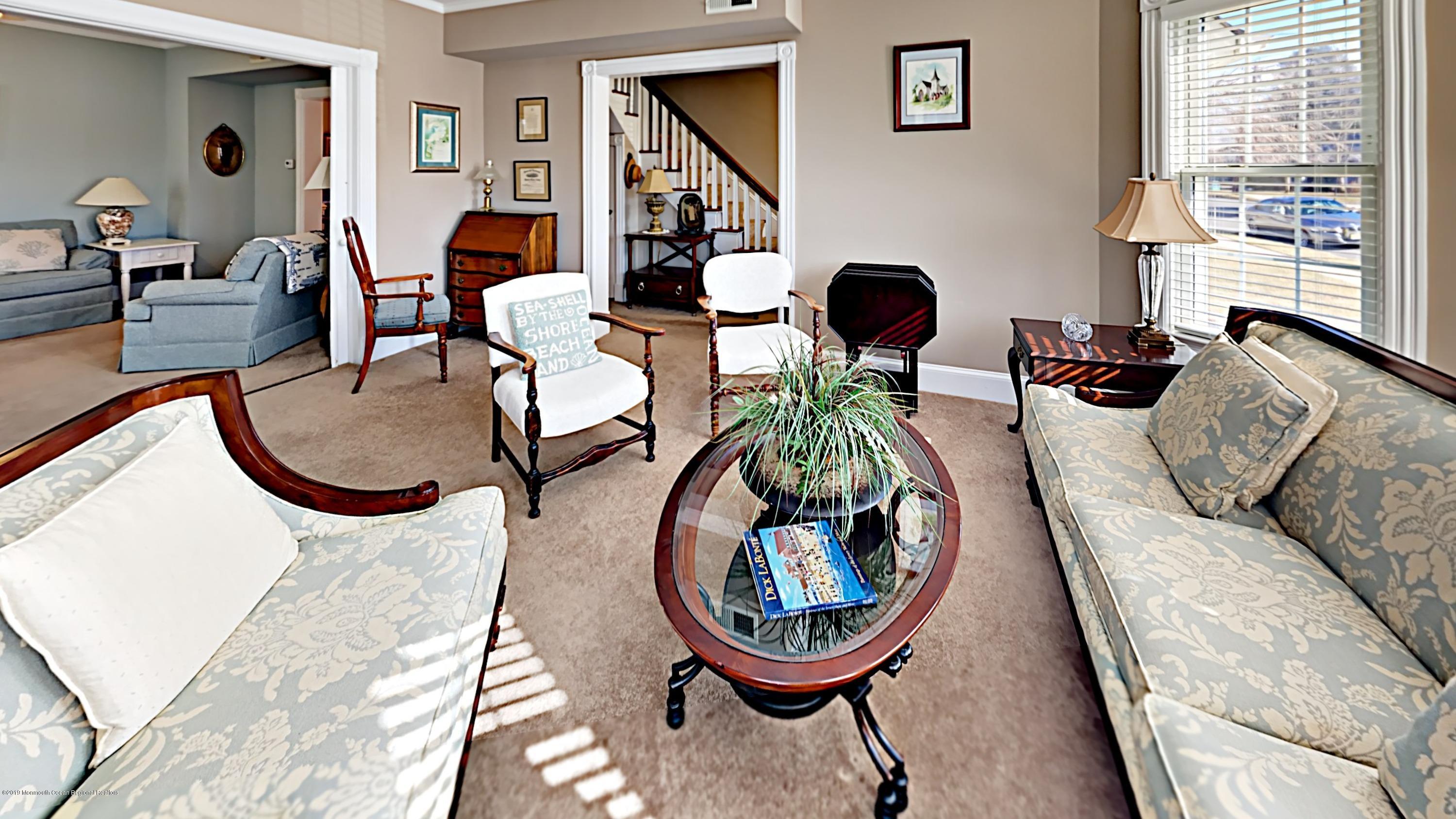 606 Ocean Road Spring Lake Heights, NJ 07762 - Photo 10 of 42 a living room with furniture and a wooden floor