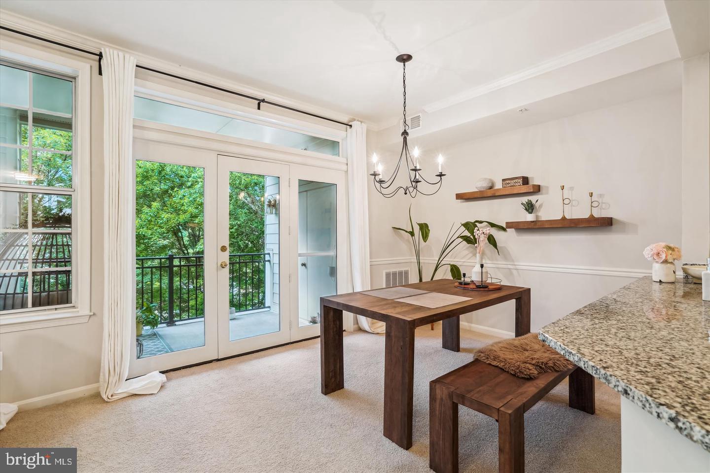 a kitchen with a table chairs and white cabinets