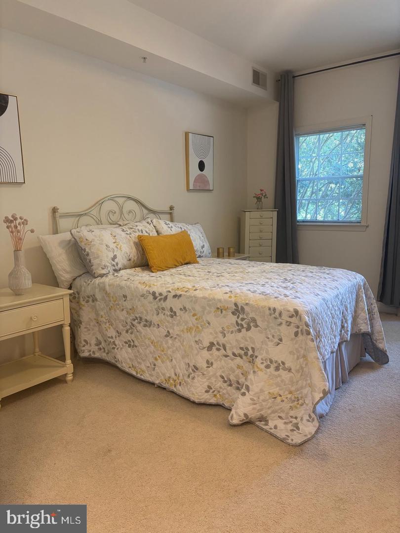 1334 Garden Wall Circle, Unit C Reston, VA 20194 - Photo 11 of 22 a bedroom with a bed and a window