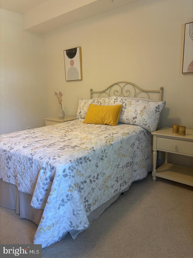 1334 Garden Wall Circle, Unit C Reston, VA 20194 - Photo 12 of 22 a bedroom with a bed and dresser