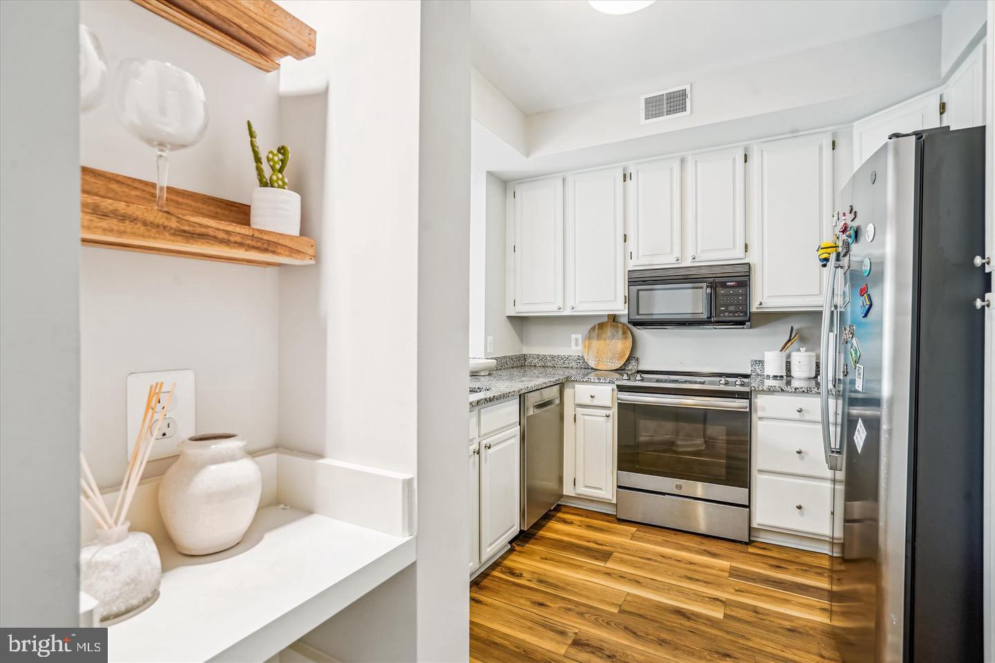 1334 Garden Wall Circle, Unit C Reston, VA 20194 - Photo 8 of 22 a kitchen with a sink a stove and refrigerator
