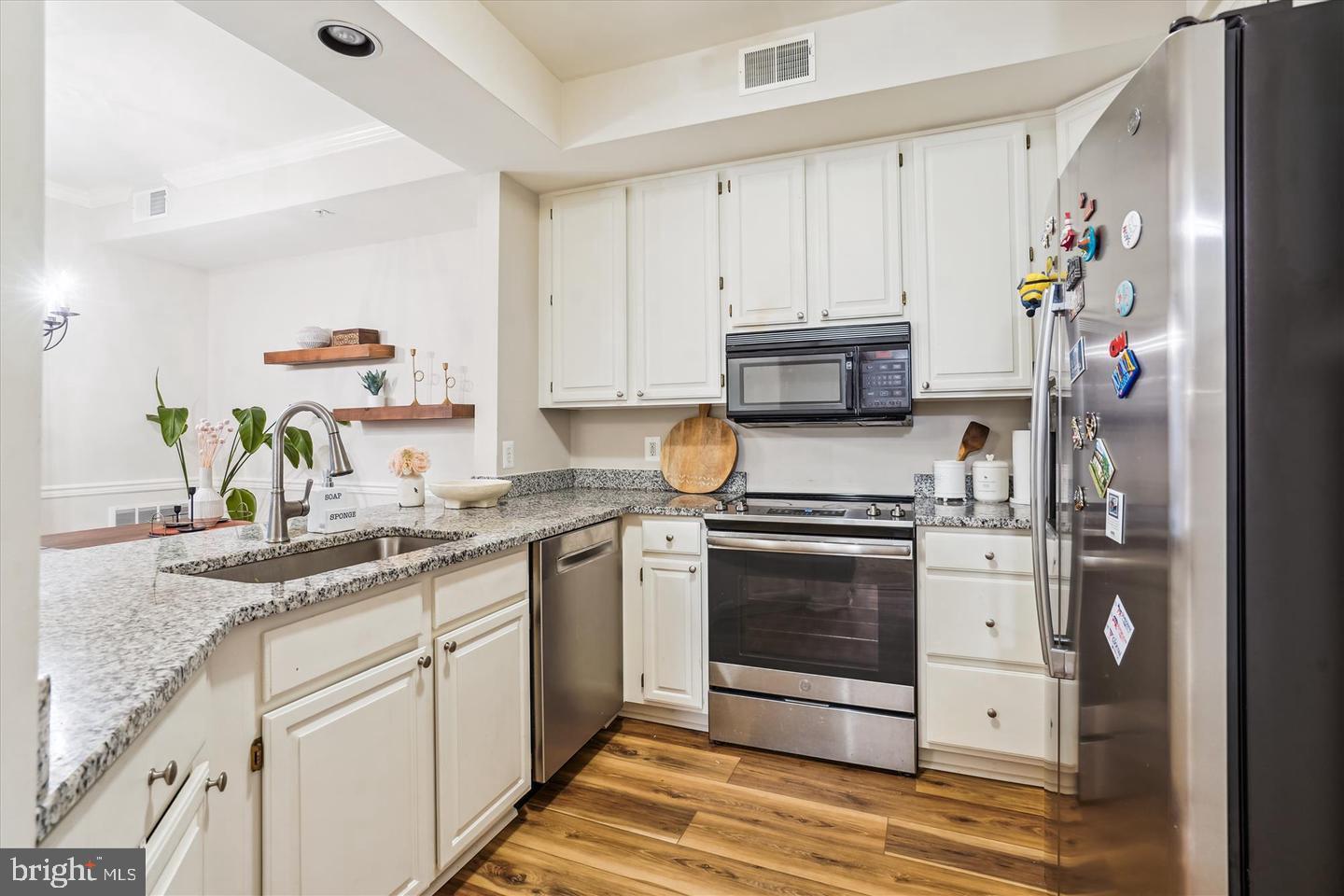 1334 Garden Wall Circle, Unit C Reston, VA 20194 - Photo 9 of 22 a kitchen with stainless steel appliances granite countertop a stove a sink and a refrigerator