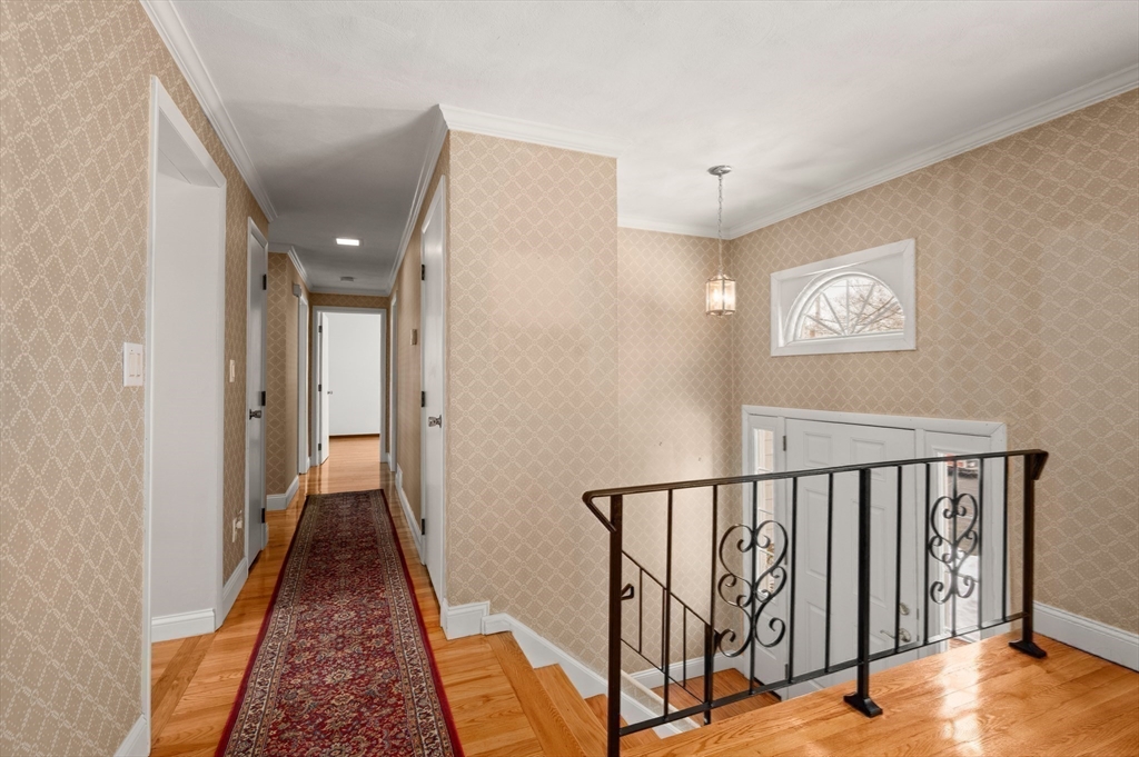 2 Iroquois Road Danvers, MA 01923 - Photo 12 of 30 a view of a hallway with wooden floor and staircase