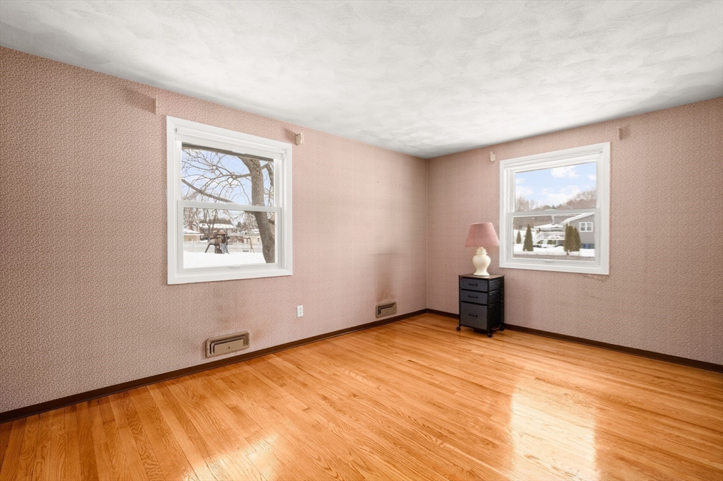 2 Iroquois Road Danvers, MA 01923 - Photo 13 of 30 a view of an empty room with wooden floor and a window