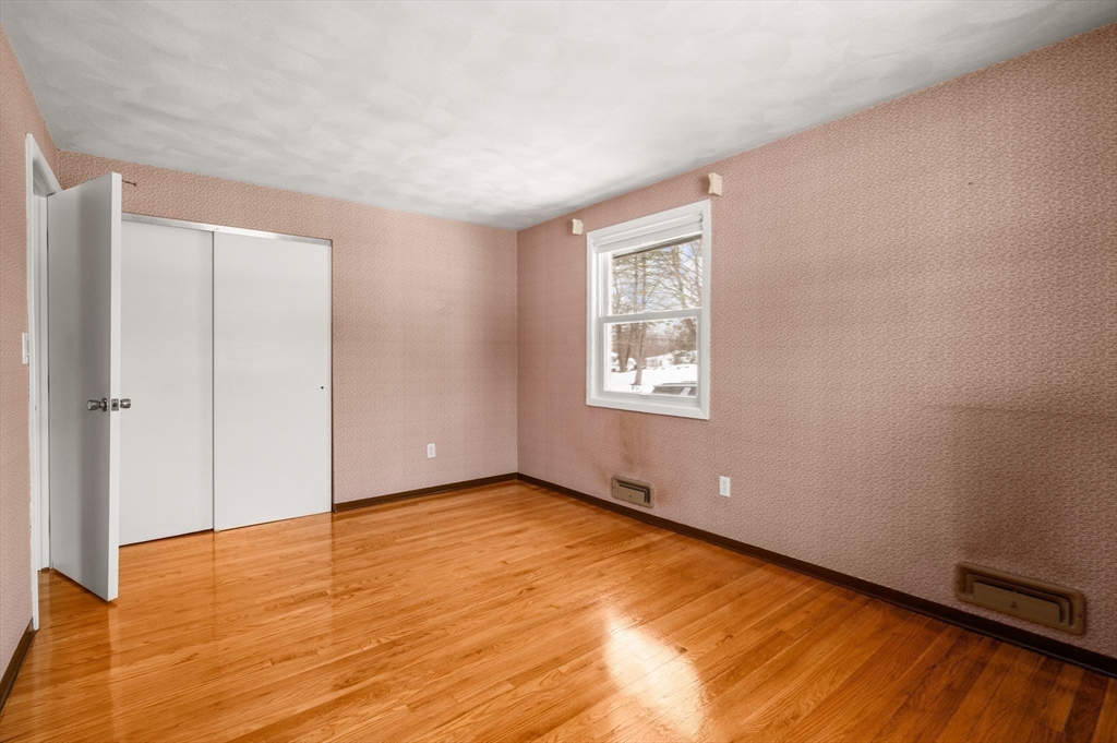 2 Iroquois Road Danvers, MA 01923 - Photo 14 of 30 a view of an empty room with wooden floor and a window