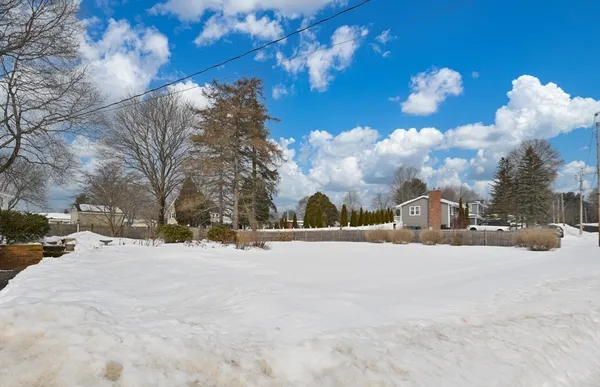 a view of a house with a snow in the yard