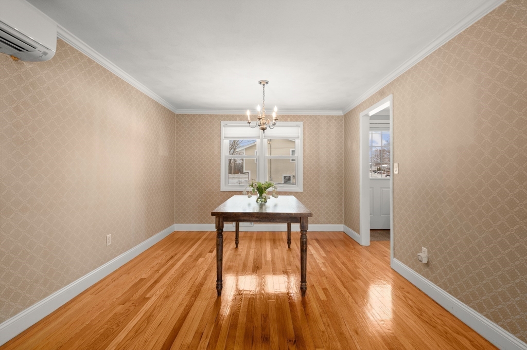 2 Iroquois Road Danvers, MA 01923 - Photo 6 of 30 a dining room with wooden floor a chandelier a wooden table and chairs