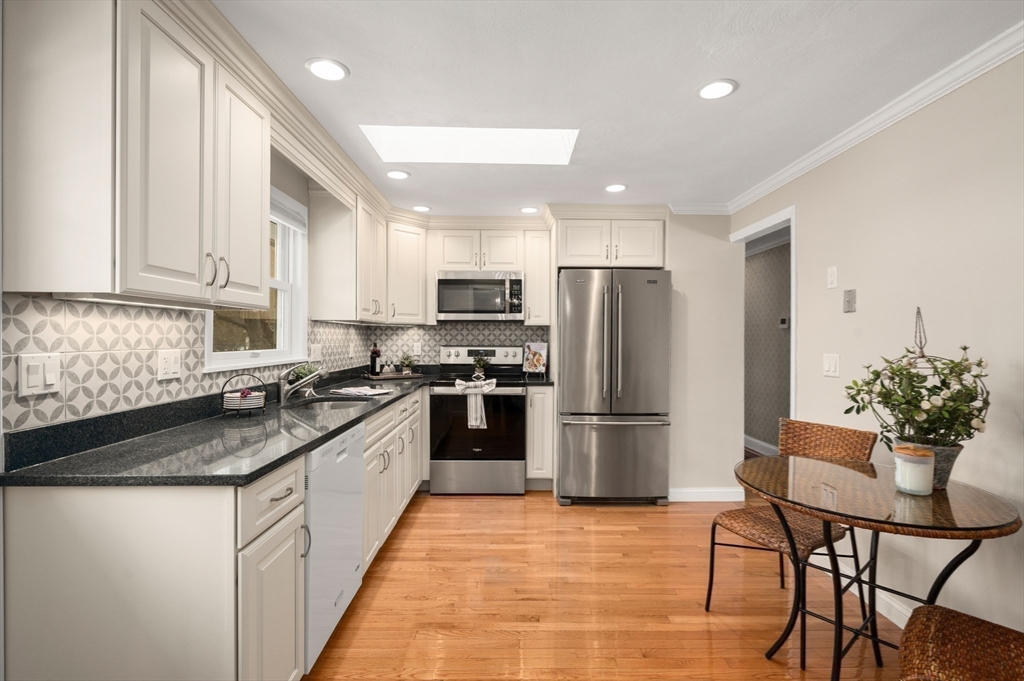 2 Iroquois Road Danvers, MA 01923 - Photo 7 of 30 a kitchen with a refrigerator a stove a sink and chairs