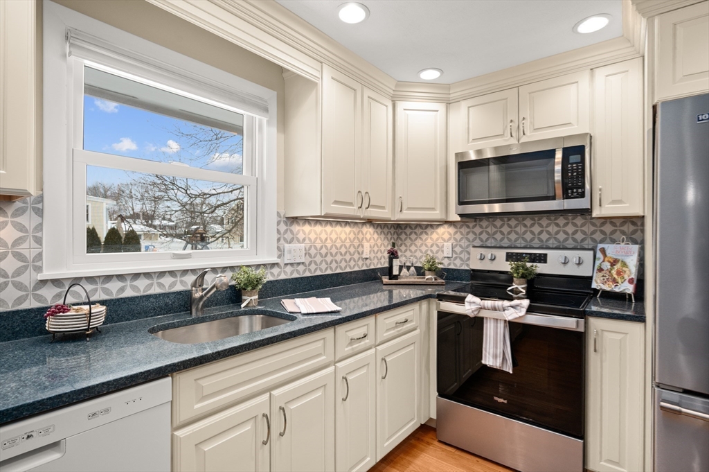 2 Iroquois Road Danvers, MA 01923 - Photo 8 of 30 a kitchen with granite countertop a sink and a stove top oven