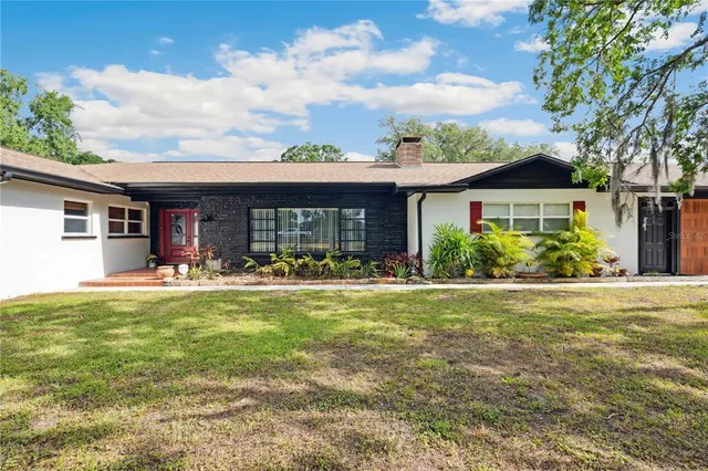 a view of a house with swimming pool and a yard