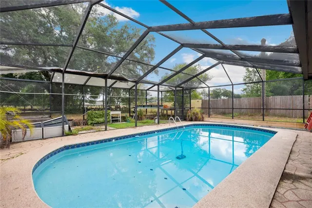 a view of a house with backyard porch and sitting area