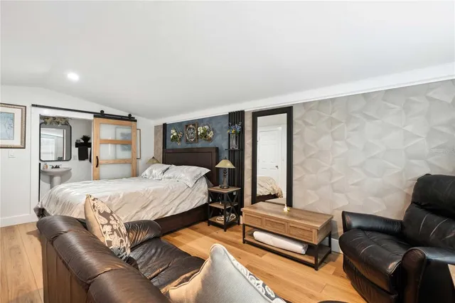 an aerial view of residential houses with outdoor space and lake view